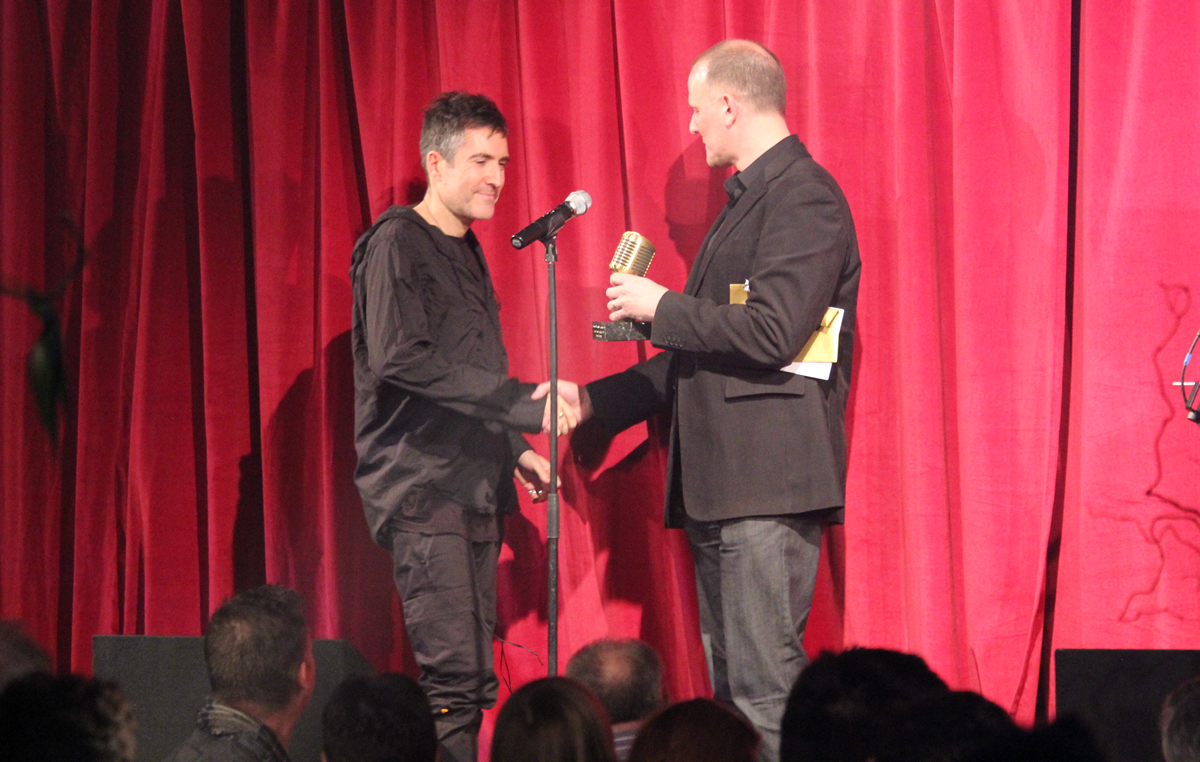 Richard Russell collects the "MPG Inspiration Award", on behalf of Damon Alburn, from Martin Warr of Synthax Audio UK