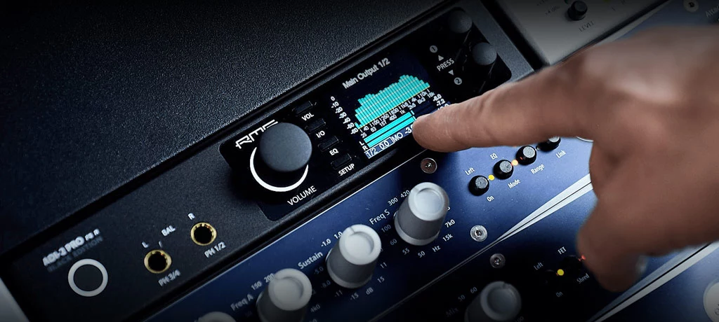 Finger pointing to the display of the RME ADI-2 Pro FS R