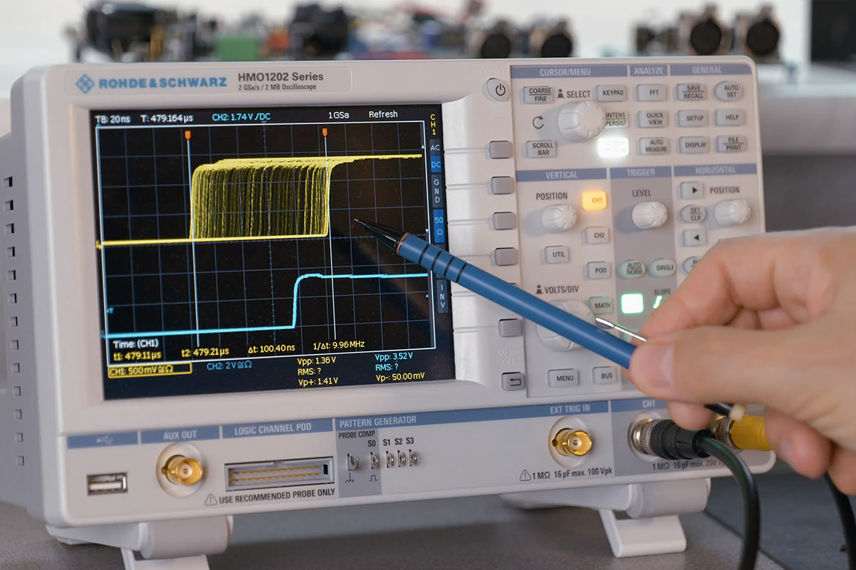 Hand using pen to point at Rohde & Schwarz HMO1202 measuring WordClock