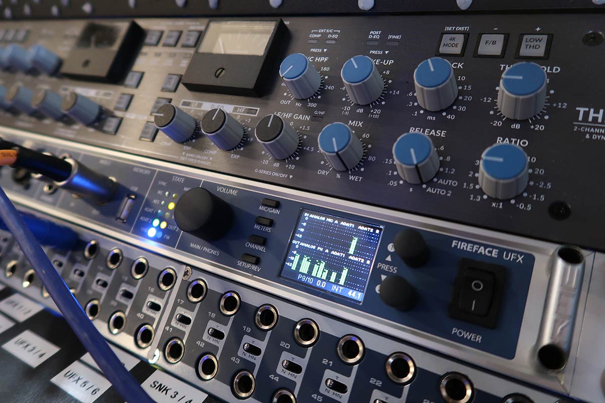 Closeup of an SSL Bus+, RME Fireface UFX and Samsung patchbay