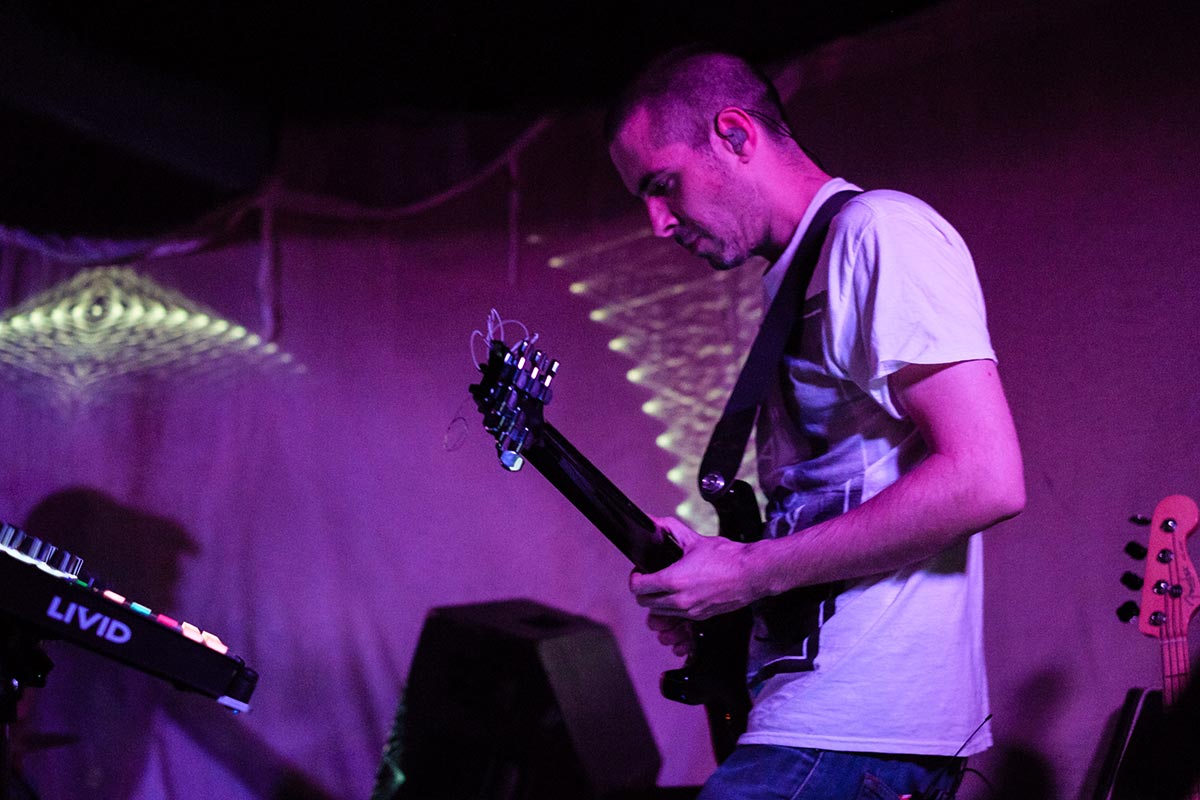 Phaeleh playing guitar on stage