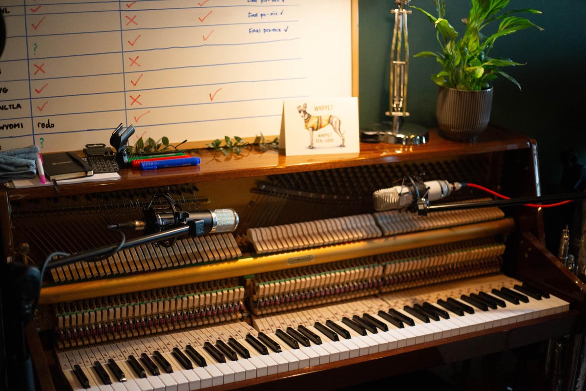 An upright piano with stereo microphones