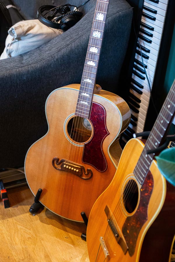 Guitars and a keyboard on a wooden floor