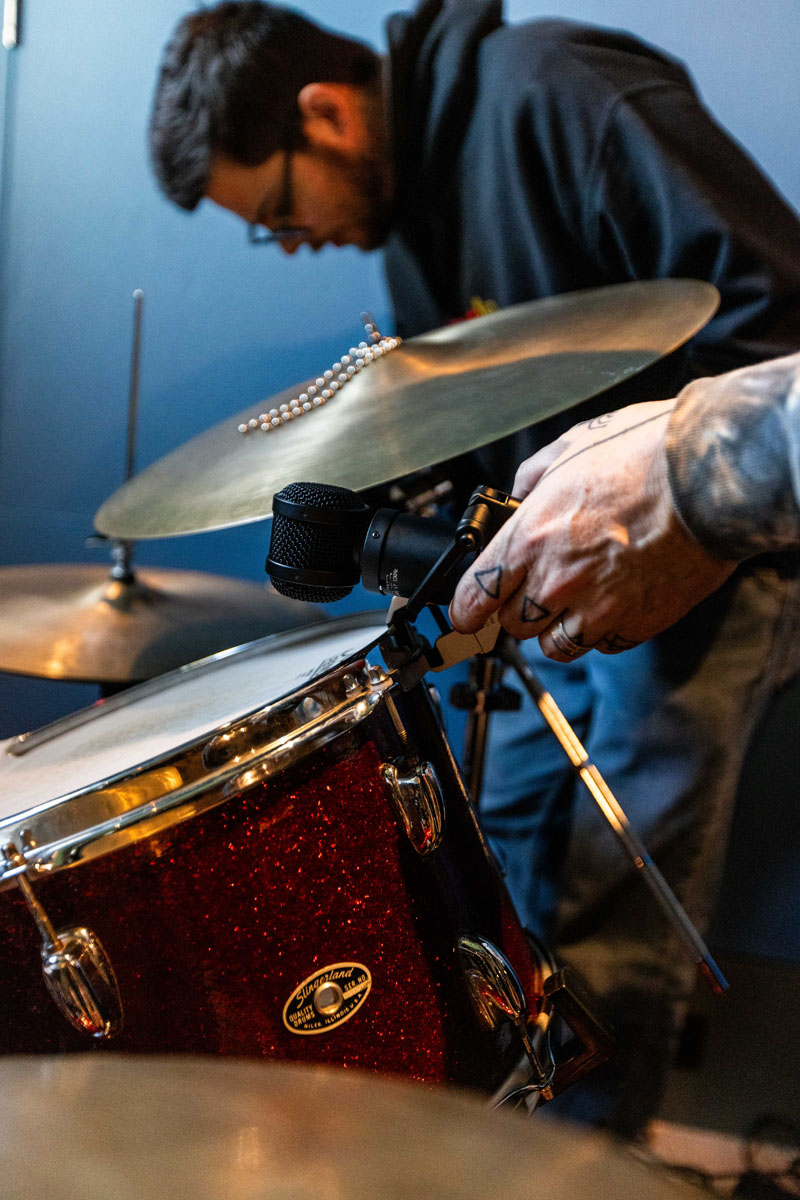 Engineers attaching Lauten Audio Rim Mounts to a drum kit