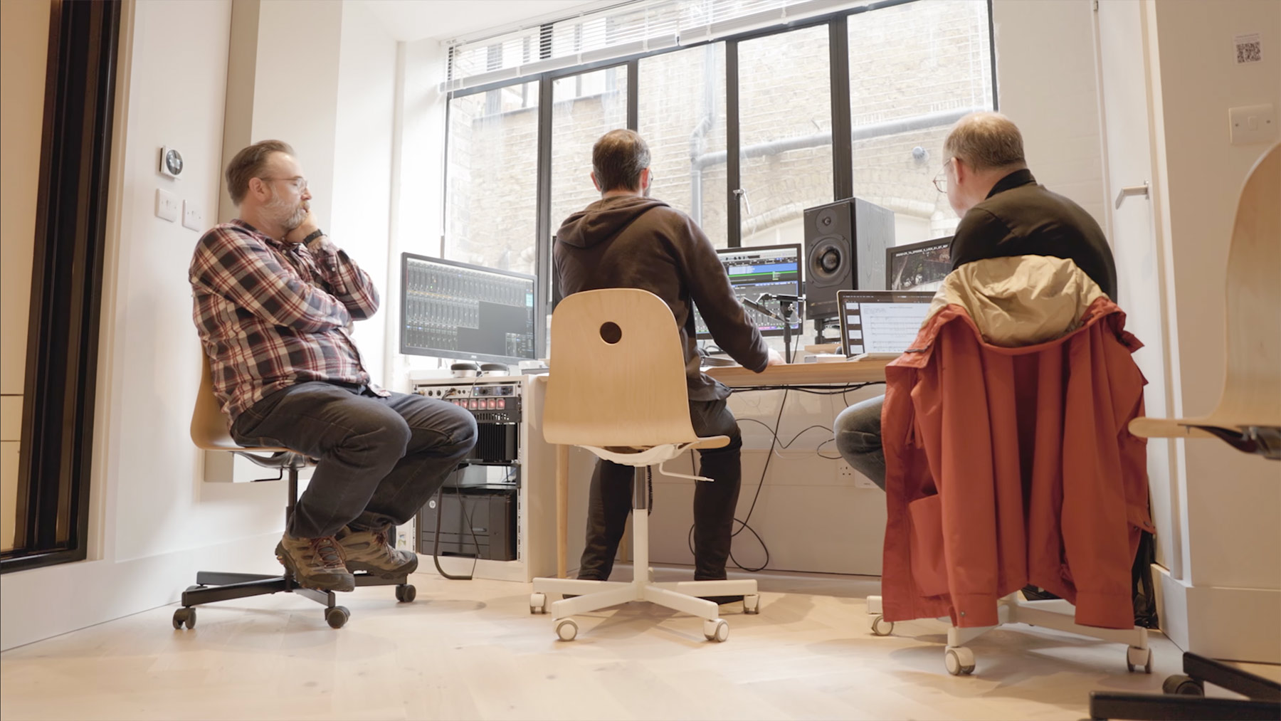 Three men sat in the programming room in Shoreditch Recording Works