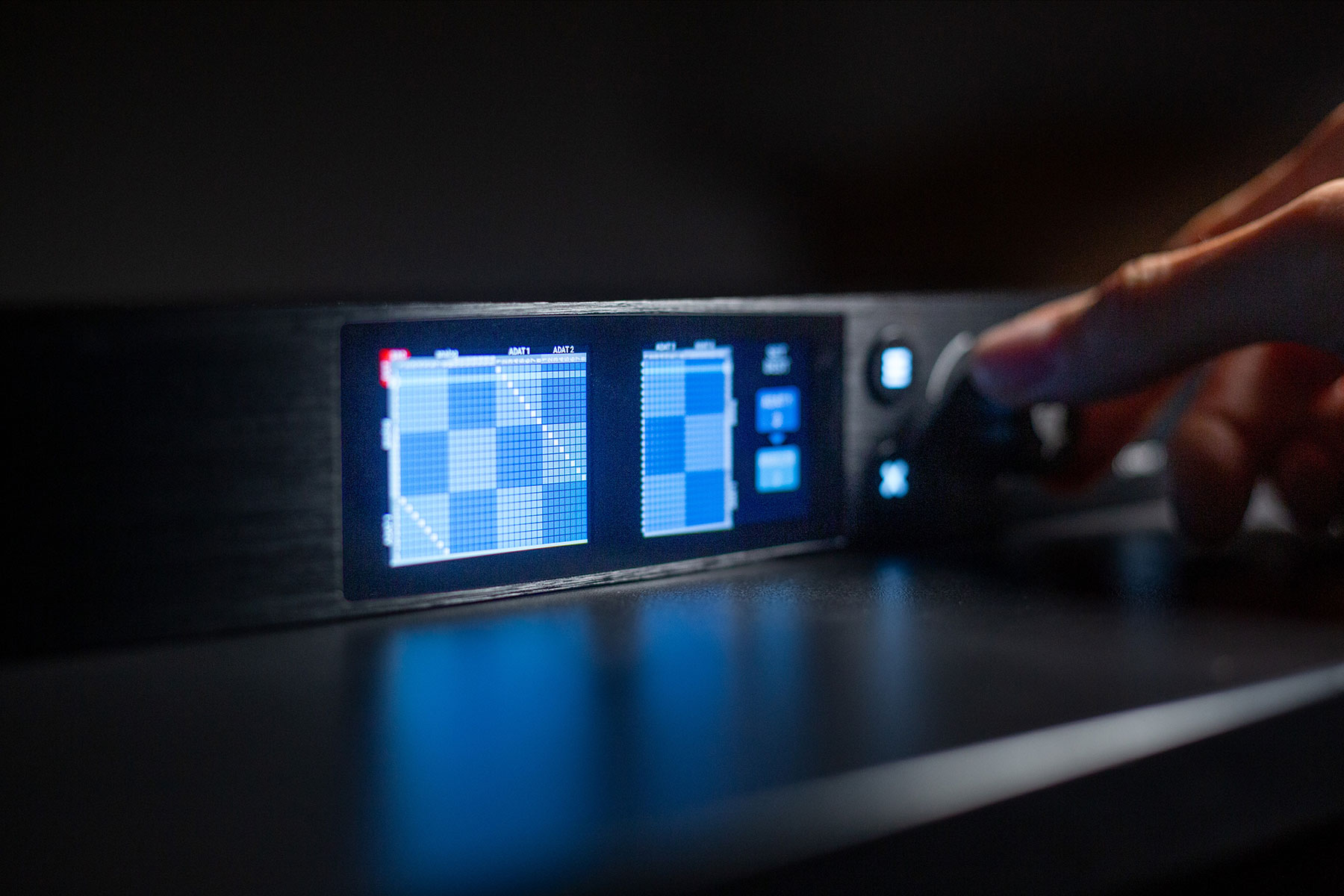 Hand using routing matrix on Pulse 16 AE front panel