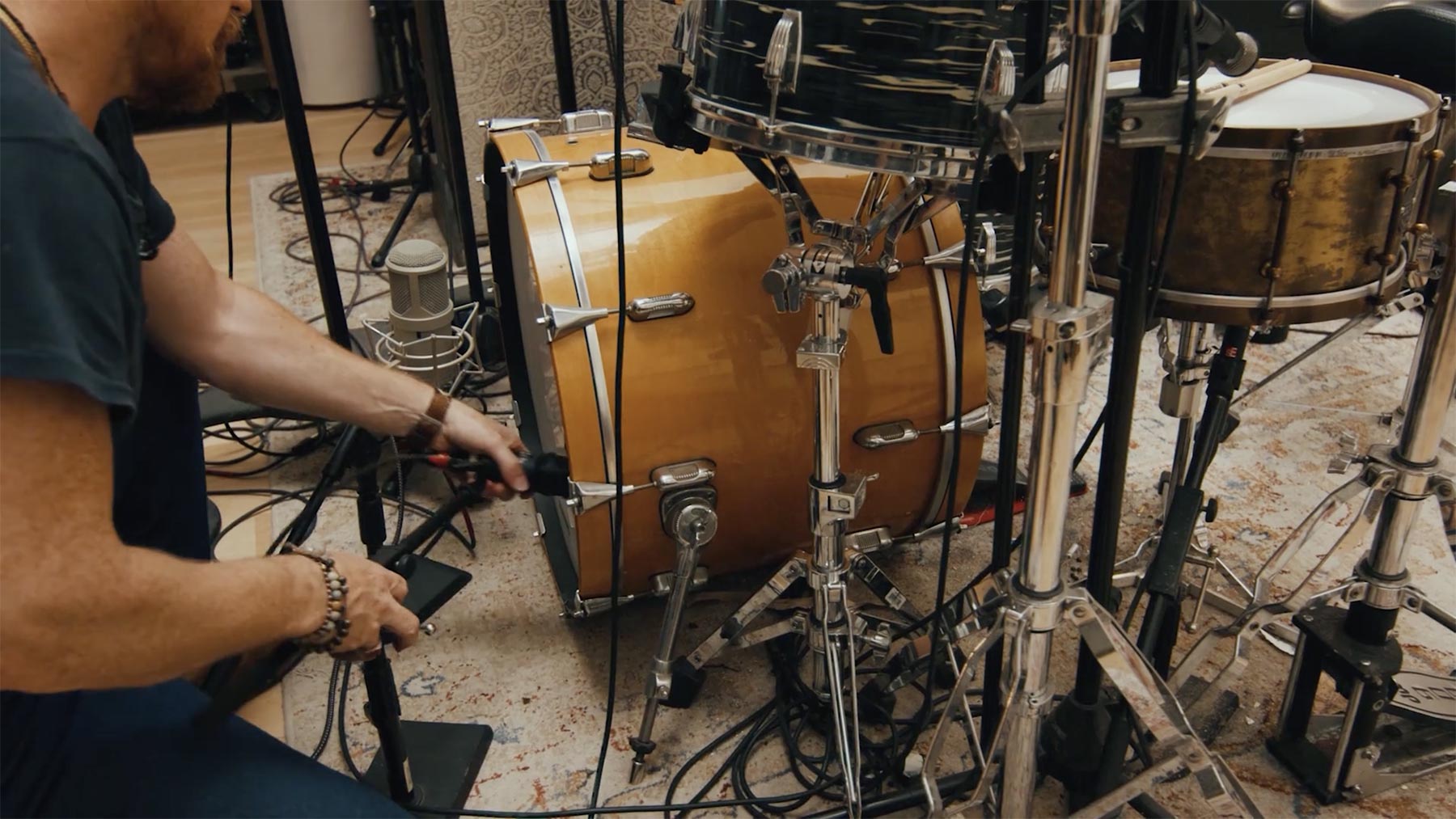 Man placing Lauten Audio Kick Mic in a bass drum