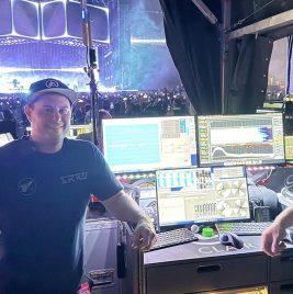 Live sound engineers Ricki Cook and Bill Chase with stage in background