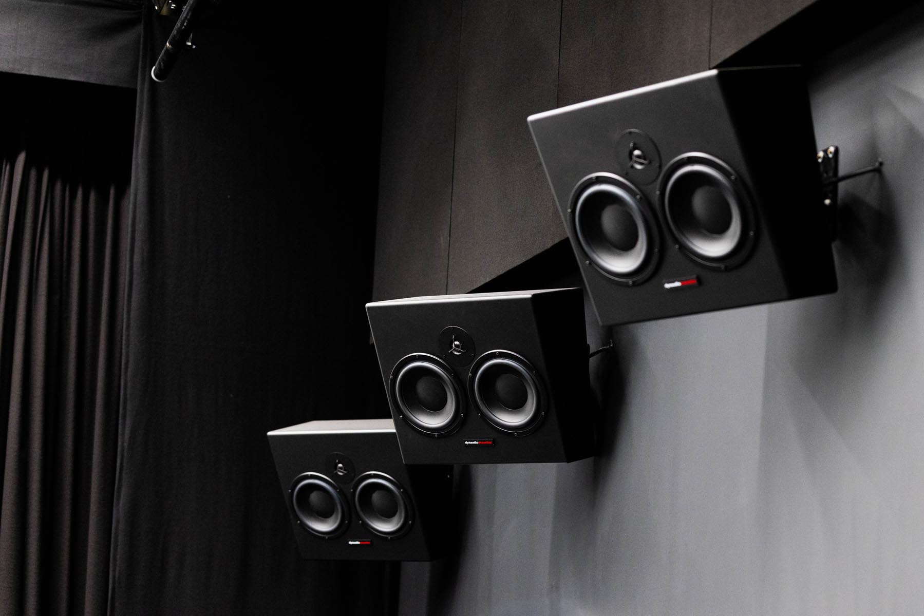 Closeup of three Dynaudio M-series MF30 surround monitors