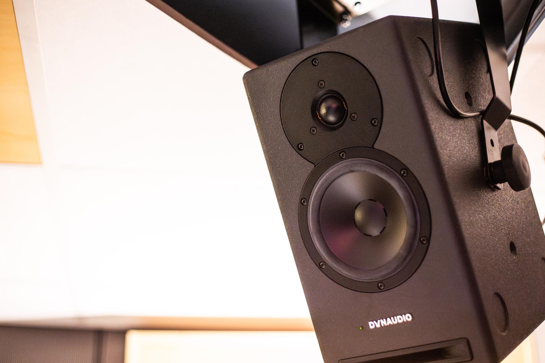 Closeup of a ceiling-mounted Dynaudio Core 5 used for surround speaker