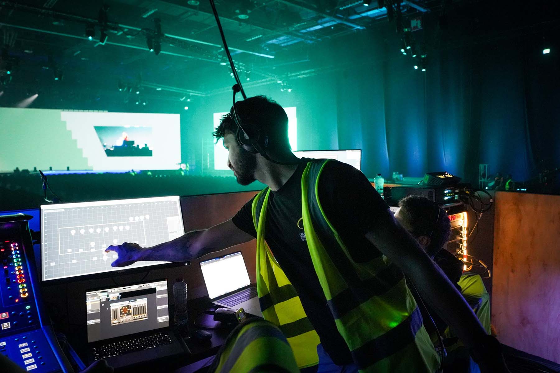 Crew member in Hi-Vis vest touching a screen at front of house at G42 Supercharged 2025
