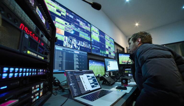 Man on phone inside Vivid's broadcast Remote Production Centre (RPC)