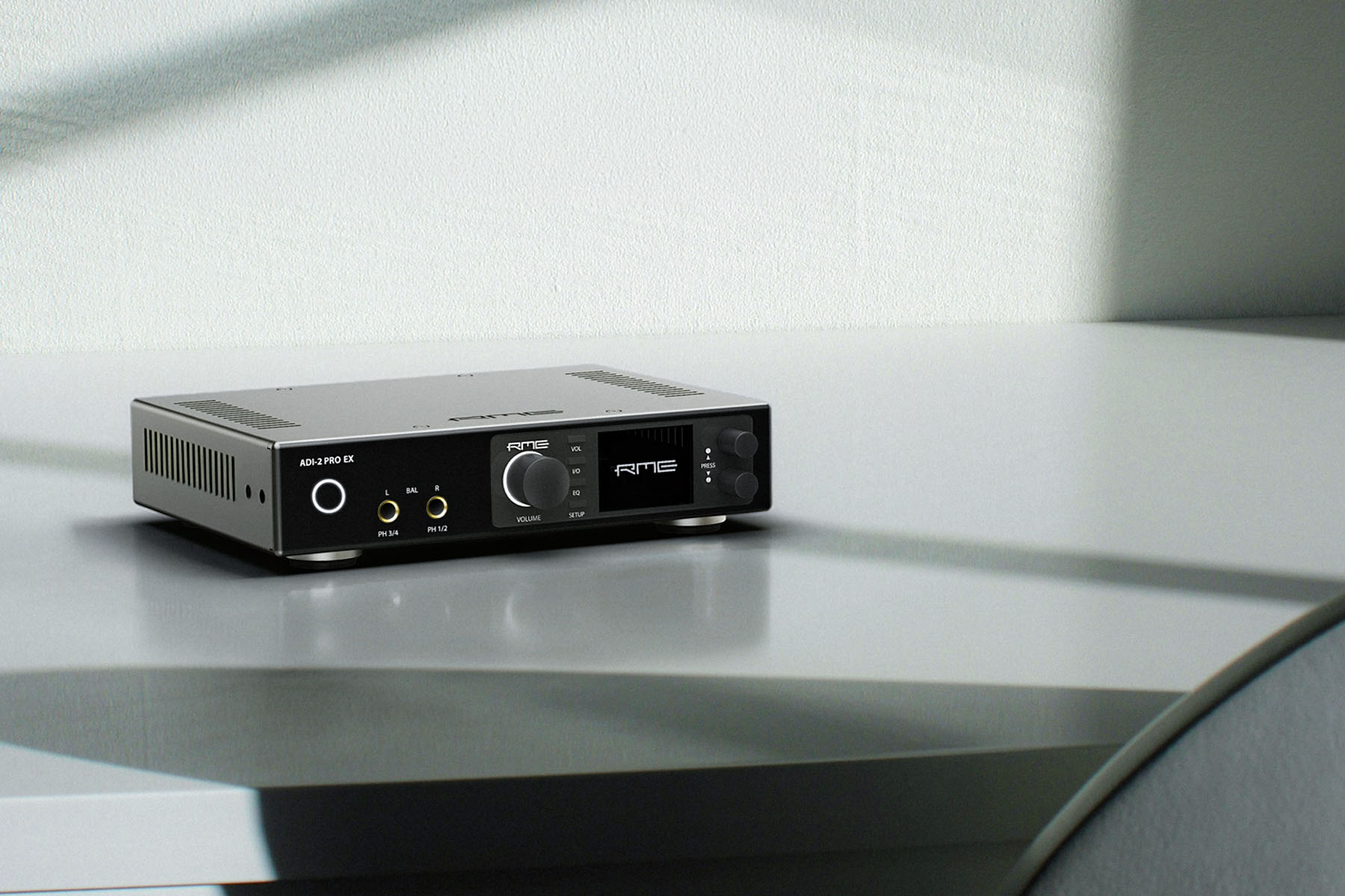 RME ADI-2 Pro EX converter on a reflective coffee table