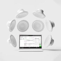 Speakers floating around a laptop running SoundID Reference software