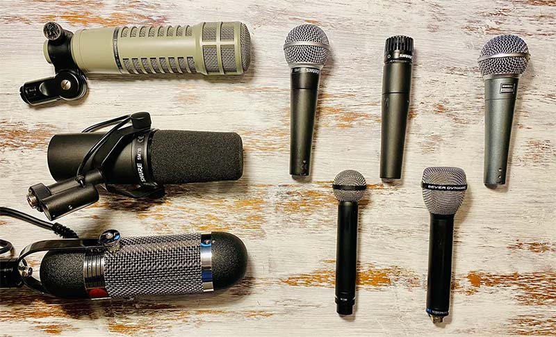 Top-down view of some microphones on a wooden surface
